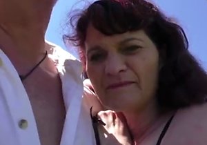 Outdoor gang-bang for a timid-looking MILF