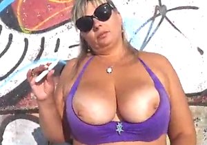 Tanned bitch shows her pussy and sexy legs outdoors